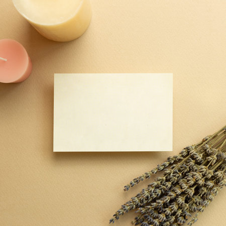 Aroma therapy concept. Memo pad, empty paper with dry lavender flowers and candles on beige...