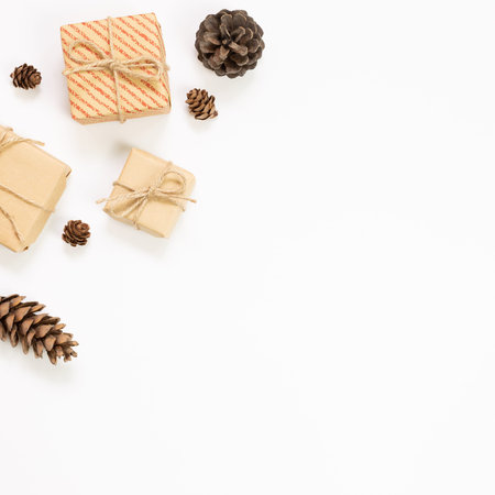 Gift boxes with pine cones on white background. Autumn and winter concept. flat lay, top view, copy...