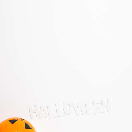 Pumpkin and Halloween text on white background. top view, copy spaceの写真素材
