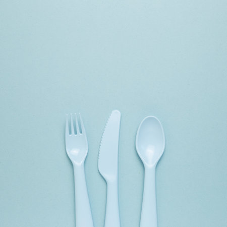 Fork knife spoon on sky blue background. flat lay, top view, copy spaceの写真素材
