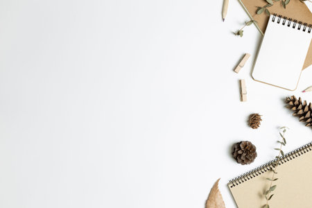 Work and study place. Notebook and dry plant on white background. flat lay, top view, copy space