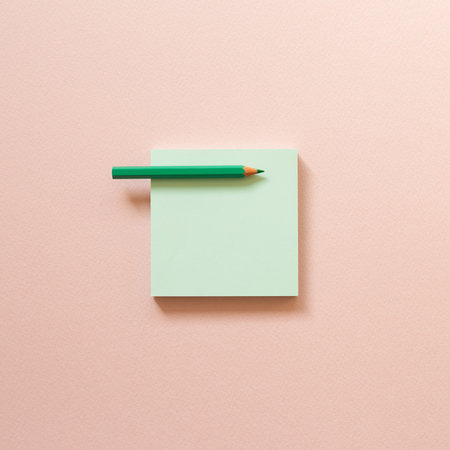 Green memo paper, sticky notes with colored pencil on pink background. top view, copy space