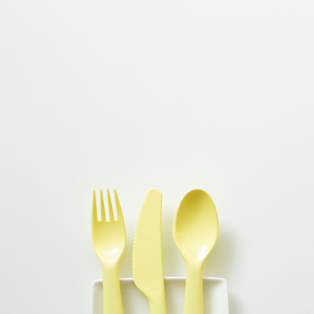 Yellow fork knife spoon on white background. flat lay, top view, copy space