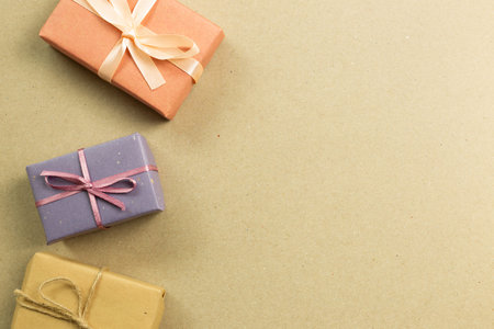 Colorful gift boxes on brown kraft paper background. flat lay, top view, copy space
