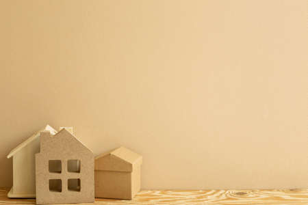 House model on wooden table. brown background. Real estate concept. copy spaceの写真素材