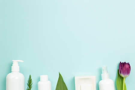 Bathroom white bottles and soap on blue background. flat lay, top view, copy space. Skin care and spa conceptの写真素材