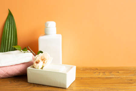 Bathroom bottle, shower towel, soap on wooden table. Skin care and spa conceptの写真素材