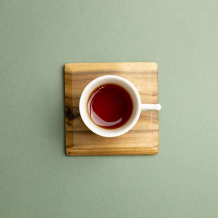 Cup of black tea on green background. top view, copy spaceの写真素材