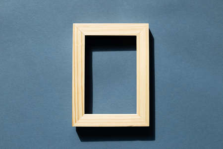 Wooden picture frame on navy blue background. top view, copy spaceの写真素材