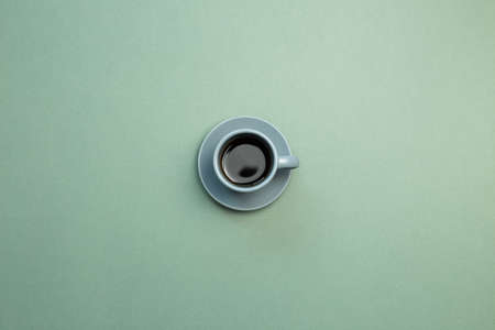 Cup of coffee on green background. top view, copy spaceの写真素材