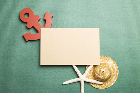 Blank memo pad and starfish, anchor, straw hat on green background. summer marine decoration. top...