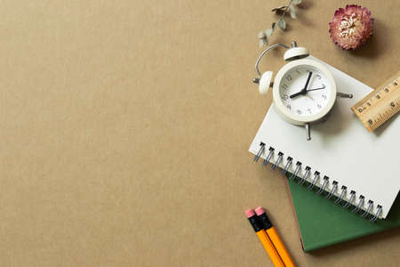 Various office supplies on brown background. workspace. flat lay, top view, copy spaceの写真素材