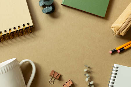 Various office supplies on brown background. workspace. flat lay, top view, copy spaceの写真素材
