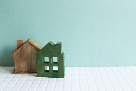 House model on white ceramic mosaic tile table. mint background. real estate conceptの写真素材