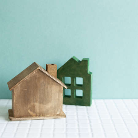 House model on white ceramic mosaic tile table. mint background. real estate conceptの写真素材