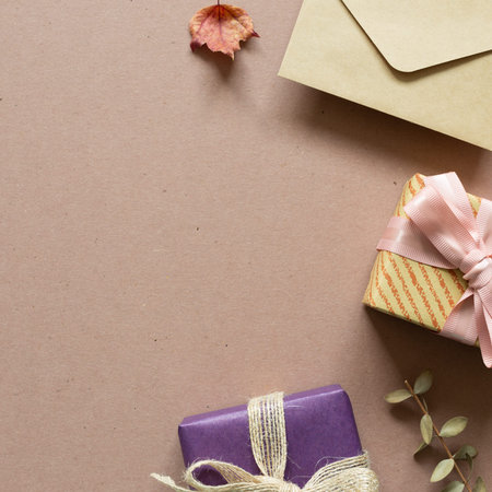 Gift box, envelope on brown background. anniversary, christmas, greeting concept. flat lay, top...