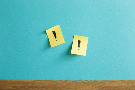 Sticky notepad with exclamation mark on blue wall. Thinking, solution, business, idea conceptの写真素材
