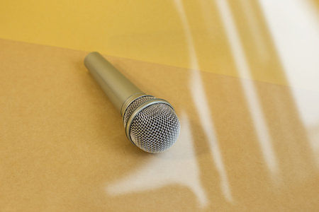 Microphone on brown floor background. from glass windowの写真素材