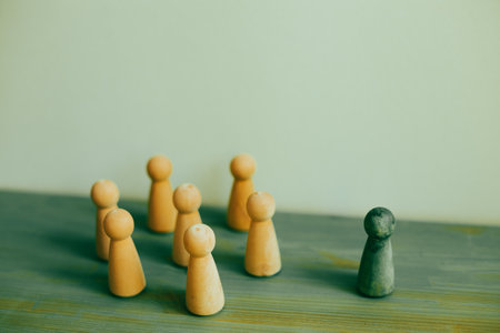 Majority vs minority concept. Wooden human figure on desk. green backgroundの写真素材