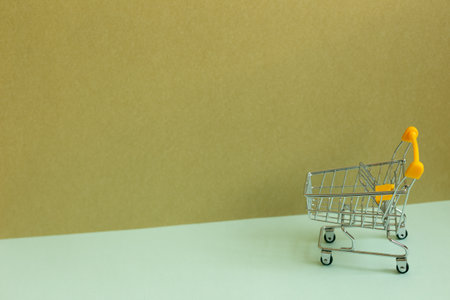 Shopping cart on sky blue and khaki background. business conceptの写真素材