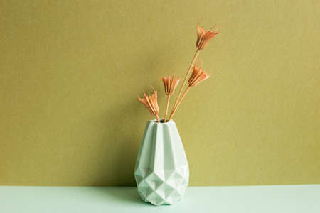 Vase of dry flower on sky blue table. khaki wall background. home interiorの写真素材