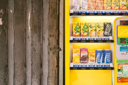 Hong Kong - March 15, 2017 : Yellow vending machine and shutter in Tai o fishing villageのeditorial素材