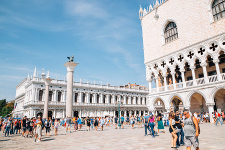 Venice, Italy - August 18, 2016 : Biblioteca Nazionale Marciana and Doge's Palace with crowd at...