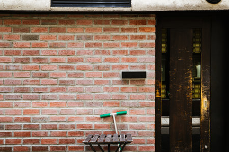 Wooden door and brown brick wall in Fukuoka, Japanのeditorial素材