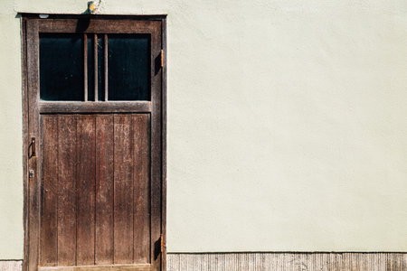 Old wooden door and beige wall in Kyoto, Japanのeditorial素材