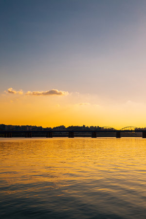 Dongjak Bridge and modern cityscape with Han River under dramatic sunset sky from Banpo Hangang Park in Seoul, Koreaのeditorial素材