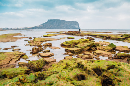 Seongsan Ilchulbong Tuff Cone and Gwangchigi Beach in Jeju Island, Koreaのeditorial素材