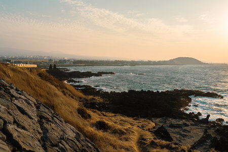 Sunset sea and Dodubong, Jeju Olle Trail route 17 in Jeju Island, Koreaのeditorial素材