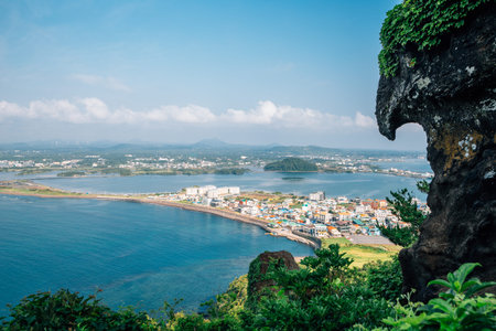 Panoramic view of seaside village from Seongsan Ilchulbong Tuff Cone in Jeju Island, Korea