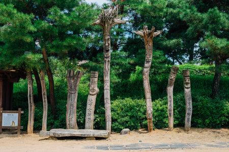 Asan, Korea - August 3, 2016 : Jangseung, Korean traditional totem pole with green treeのeditorial素材