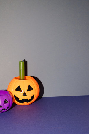 Halloween party decor, pumpkin and candle on blue background