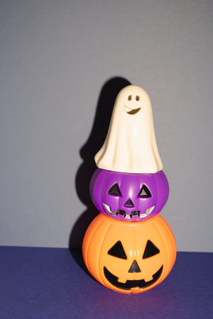 Halloween party decor, ghost and pumpkin on blue background