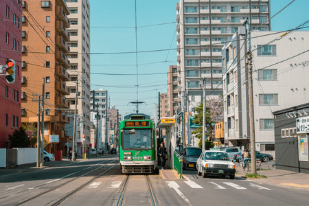 Sapporo, Hokkaido, Japan - April 25, 2023 : Sapporo city street and old tram