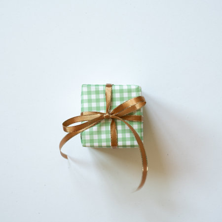 Green check pattern gift box isolated on white background. top view, copy spaceの写真素材