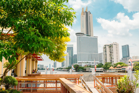 Chao Phraya River pier dock and skyscraper in Bangkok, Thailandのeditorial素材