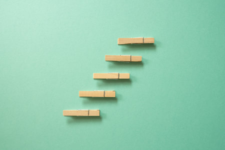 Stairs wood clip on green background. achievement, development, challenge conceptの写真素材