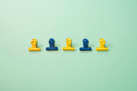 Paper binder clip isolated on green background. top viewの写真素材