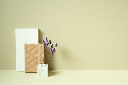 Notebook and diary, vase of dry flower on desk. khaki beige backgroundの写真素材