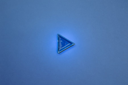 Blue right direction arrow on navy blue background. top viewの写真素材