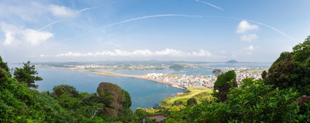 Panoramic view of sea and city from Seongsan Ilchulbong Tuff Cone in Jeju Island, Koreaのeditorial素材