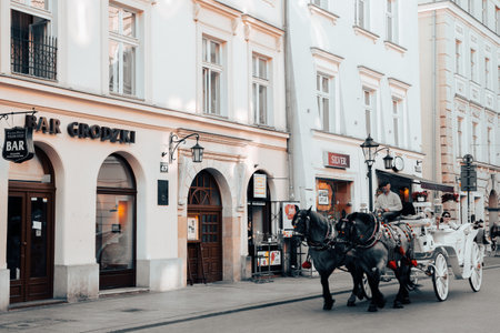 Krakow, Poland - June 17, 2019: Krakow old town, horse carriage with touristsのeditorial素材