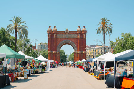 Barcelona, Spain - June 29, 2025: Summer scenery of Arc de Triomf and street market