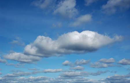 Clouds of different size on blue skyの写真素材