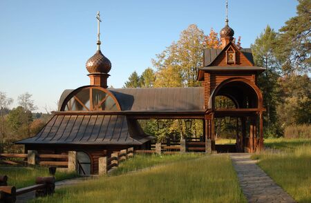 Small wooden font staying among autumn trees in the forestの写真素材