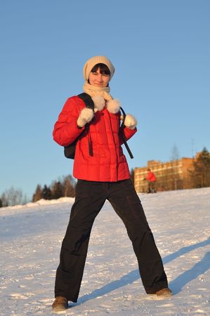 Winter portrait of young woman posing on hillの写真素材