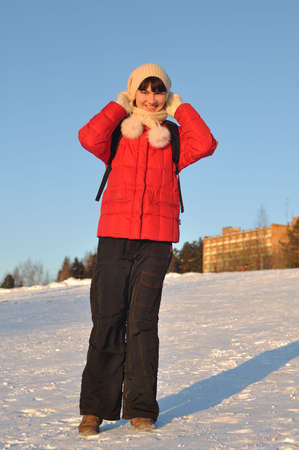Winter portrait of young woman posing on hillの写真素材